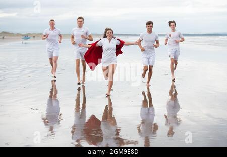 St Andrews, UK. Sept 17th 2021: Recreating the famous Chariots of Fire race on the West Sands, members of the St Andrews tennis club celebrating the University of St Andrews being named number one University in the UK, overtaking both Oxford and Cambridge for the first time ever in the Times and Sunday Times Good University Guide 2022 (left to right): Mark Brocklebank, Fin Pearson, Lily Turner (wearing the iconic St Andrews red Undergraduate gown), Gregory Dritschel and Timothy Moore. Credit: Gayle McIntyre/Alamy Live News