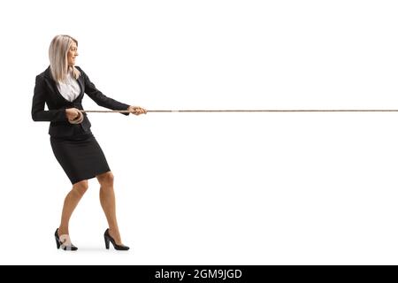 Full length profile shot of a young attractive businesswoman pulling a rope isolated on white background Stock Photo
