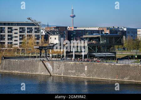 Main river promenade and the restaurant Oosten with the skyline of Frankfurt in the background Stock Photo