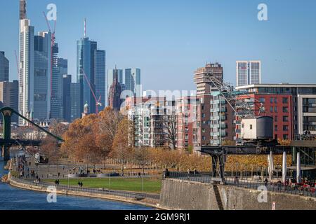 Main river promenade and the restaurant Oosten with the skyline of Frankfurt in the background Stock Photo