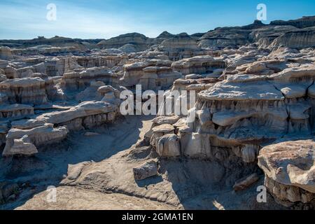 Seemingly infinite numbers of pillars and columns seem to support the upper layers of the rock formations in parts of the Bisti Badlands Stock Photo