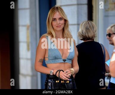 Milan, . 17th Sep, 2021. Milan, 09/17/2021 Chiara Ferragni arrives in the  center to go shopping - The day is hot and she decides to take off her  jacket, practically remaining in a Prada denim bra. After a few selfies  with guys who recognized her, she enters