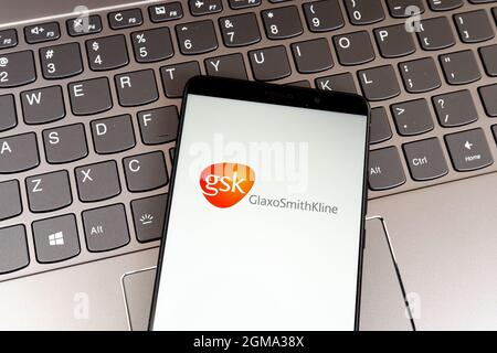 GlaxoSmithKline (GSK) logo on smartphone screen on keyboard. Stock Photo