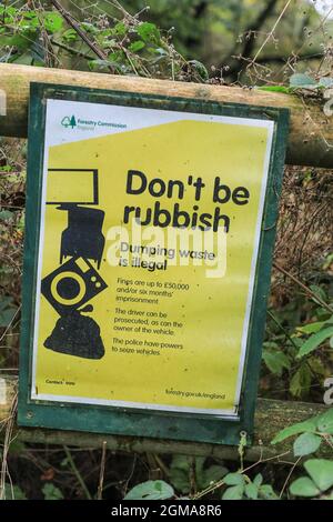 A sign or notice by The Forestry Commission England saying 'don't be rubbish' and 'dumping waste is illegal', Staffordshire, England, UK Stock Photo