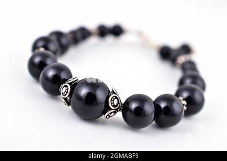 Expensive black stone bracelet isolated on white Stock Photo