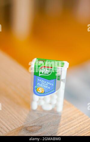 POZNAN, POLAND - Apr 13, 2016: A closeup of the mint-flavored tic tac candies in the plastic container on the wooden table Stock Photo