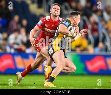 James Donaldson (25) of Leeds Rhinos is tackled by Matt Parcell (9) of Hull KR which results in Matt Parcell having to leave the field with and injury Stock Photo
