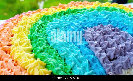 Rainbow cream cake. The buttercream is dyed with food colorings in rainbow colors to celebrate the kid's birthday in unicorn style. Original ideas of Stock Photo