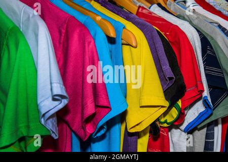 Lots of colored shirts on the hanger tidy and washed for use. Salvador Bahia Brazil. Stock Photo
