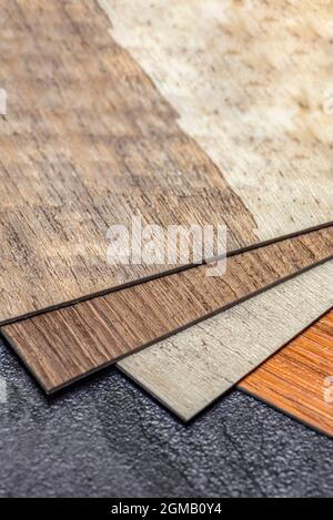 Vinyl floor, wood samples. Small colored boards. Image for design with copy space on black vinyl floor background Stock Photo