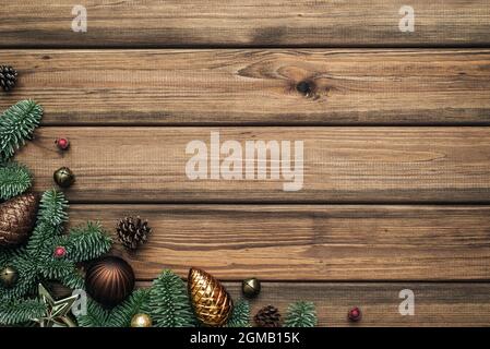 Vintage Christmas background with fir tree branches border on wooden boards. Blank with a place for text for the festive season Stock Photo