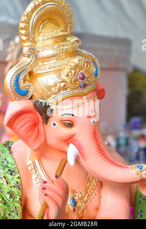 low angle side view close up of beautiful ganesha statue in blessing pose.  hinduism concept. Stock Photo | Adobe Stock