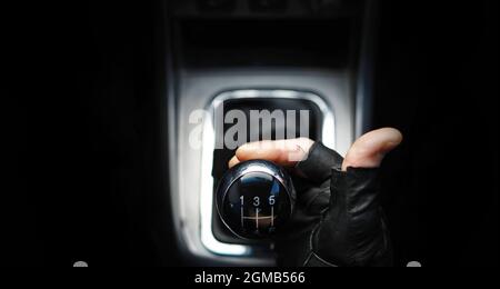 Gear lever. Manual Transmission. Hand on the gear shift in a car. Stock Photo