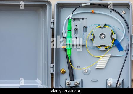 Fiber internet connection box on outside of house. Concept of fiber optic internet installation, broadband access and internet speed Stock Photo