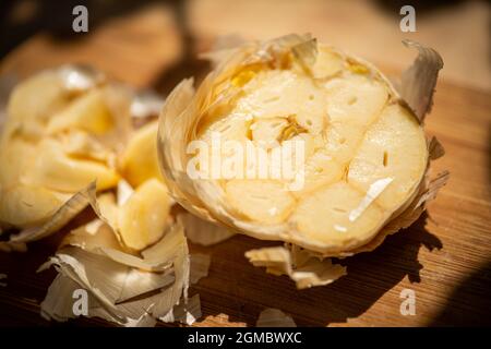 Half garlic on cutting board Stock Photo