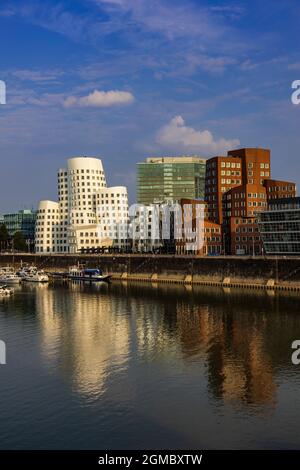 The 'Dancing Buildings' by Frank O Gehry in the evening light with copy space, at Neuer Zollhof, Medienhafen, Düsseldorf, Germany Stock Photo