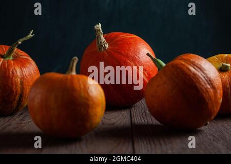 Pumpkins on wooden table with dark background. Stock Photo