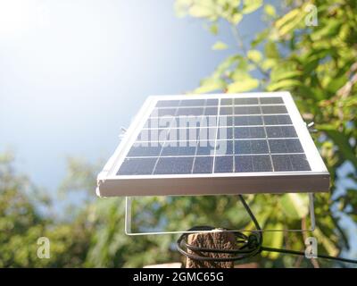 Small solar panels set on outdoor poles on a sunny day. Mini solar panel for LED spotlight in the garden. Stock Photo