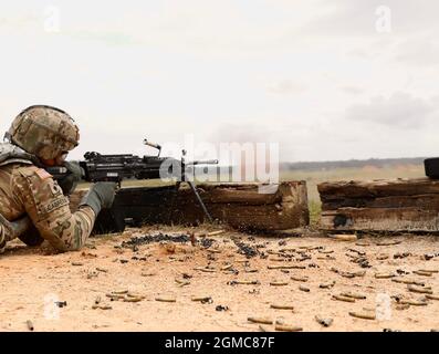 A Soldier assigned to 24th Ordnance Company, 87th Division Sustainment Support Battalion, 3rd Division Sustainment Brigade, engages a target with an M249 machine gun at Fort Stewart, Georgia Sep. 17. The company conducted qualification on the M249 and M240 machine guns to certify gunners to operate the weapon systems. (U.S. Army photo by Sgt. Laurissa Hodges, 3rd Division Sustainment Brigade Public Affairs) Stock Photo
