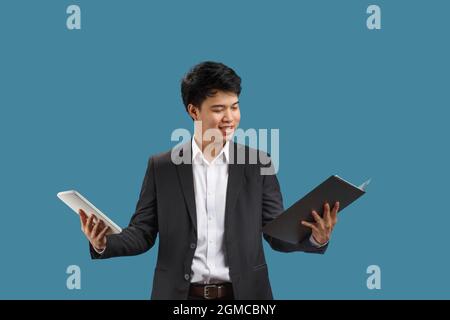 Confused young business man reading document Stock Photo