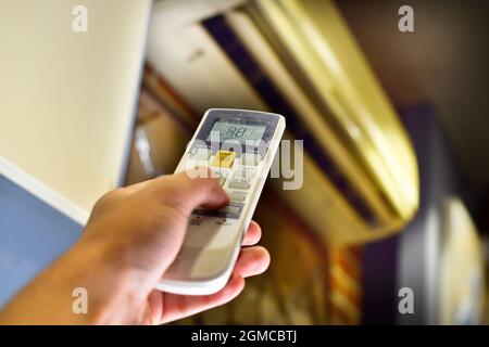 hand control air conditioner remote, controlling temperature. Stock Photo