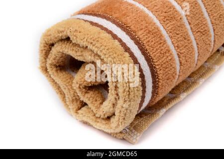 closeup of brown stripes towel isolated on white background. Stock Photo