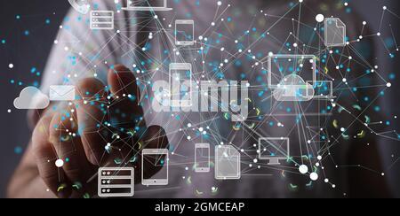 Man tapping on a virtual screen with gadgets and communication apps icons Stock Photo