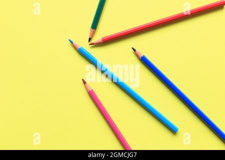 Colored pencils on a colored background. A set of pencils for drawing. Background from pencils. Stock Photo