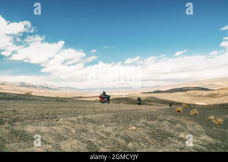 Death Valley, California, USA- April 14, 2021.   Motorcyclists ride in Death Valley, Ubehebe Crater viewpoint. Volcanic landscape, Extreme Sport, Acti Stock Photo