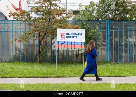 Moscow, Russia. 17th Sep, 2021. A woman walks past a sign of the State Duma elections in Moscow, Russia, on Sept. 17, 2021. Russia holds elections for deputies of the State Duma, or the lower house of parliament, on Sept. 17-19. Credit: Bai Xueqi/Xinhua/Alamy Live News Stock Photo
