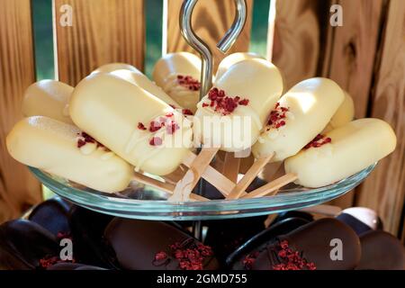 Cake pops in white and dark chocolate. Ice cream cake on a bag. Selective focus Stock Photo