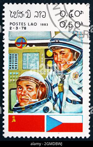 LAOS - CIRCA 1983: a stamp printed in Laos shows Cosmonauts and Flags of USSR and Czechoslovakia, Intercosmos Space Cooperation Program, circa 1983 Stock Photo