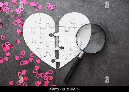 White heart-shaped puzzle. Heart affairs. Undivided love. Broken heart ...