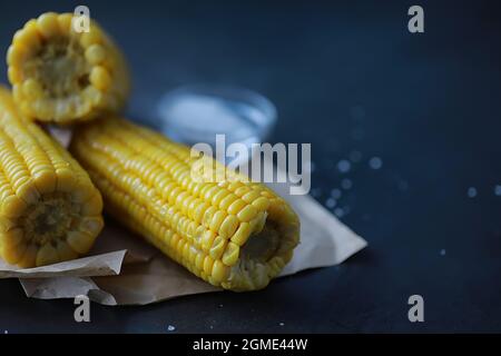 Freshly made fragrant ear of corn with salt. Farm snack fresh corn. Healthy breakfast and healthy lifestyle concept. Stock Photo
