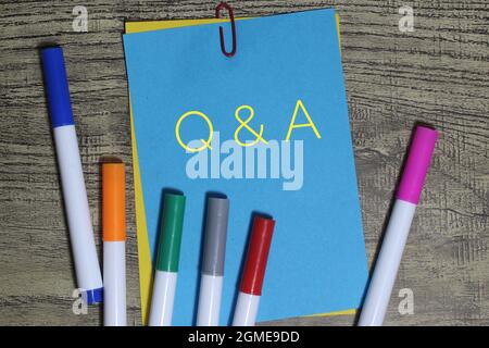 Top view of color pen and color paper with text Q and A. Question and Answer concept. Stock Photo