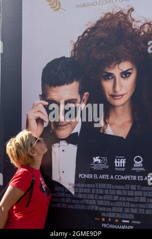 San Sebastian, Spain. 17th Sep, 2021. A visitor poses for a photo with the poster of Antonio Banderas in San Sebastian, Spain, on Sept. 17, 2021. The 69th San Sebastian Film Festival kicked off on Friday. Credit: Meng Dingbo/Xinhua/Alamy Live News Stock Photo