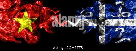 Vietnam, Vietnamese vs France, French, Martinique smoke flags side by side. Stock Photo