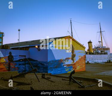 the back of the Maritime Museum of the Atlantic founded in 1948, with a beautiful surfing themed painted building with ancors all over the ground Stock Photo