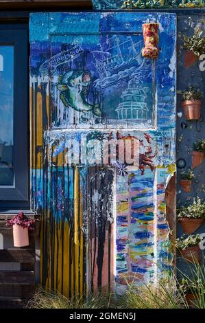 Multi coloured old front door depicting scenes from Fleetwood Stock Photo