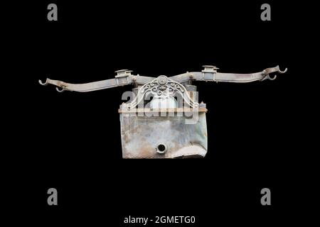 Old and rusty vintage hand fire pump, isolated on black background with clipping path Stock Photo