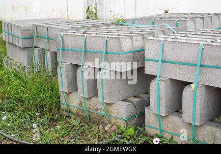 Pack of concrete blocks stacks for construction on ground with selective focus Stock Photo