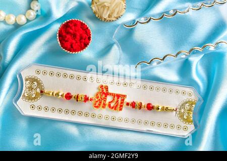 raakhi concept, raksha bandhan concept, rakhi on silk cloth with roli chawal ( bhaiya means brother) Stock Photo