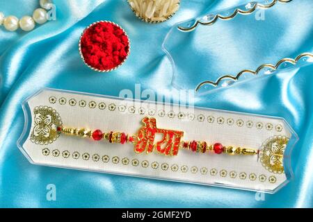 rakhi concept, raksha bandhan concept, rakhi on silk cloth with roli chawal ( bhaiya means brother) Stock Photo