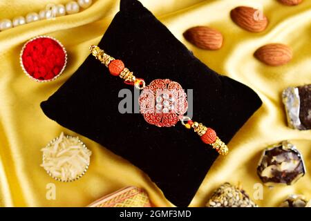 Top view of rakhi with roli chawal and sweet Stock Photo