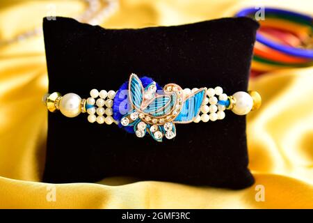 Beautiful rakhi with Roli chawal on Golden Silk Cloth Stock Photo