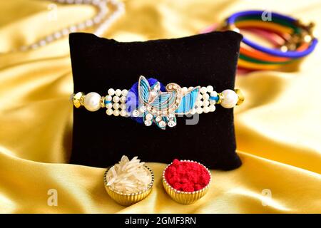 Beautiful rakhi with Roli chawal on Golden Silk Cloth Stock Photo