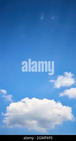 Cloud single lonely in high empty sky with beams vertical composition 16x9 with copyspace. Stock Photo
