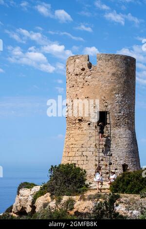 tourists visiting Cap Blanc tower built in 1579, llucmajor, Mallorca, Balearic Islands, Spain. Stock Photo