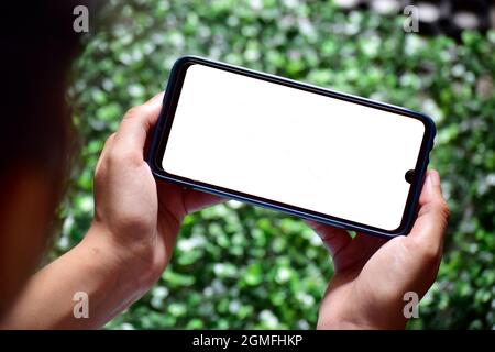Hand holding smartphone, gaming gesture Stock Photo