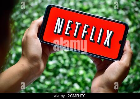 New Delhi, India - September 13, 2019: women use Netflix app on smart phone screen. Netflix is an international leading subscription service for watch Stock Photo